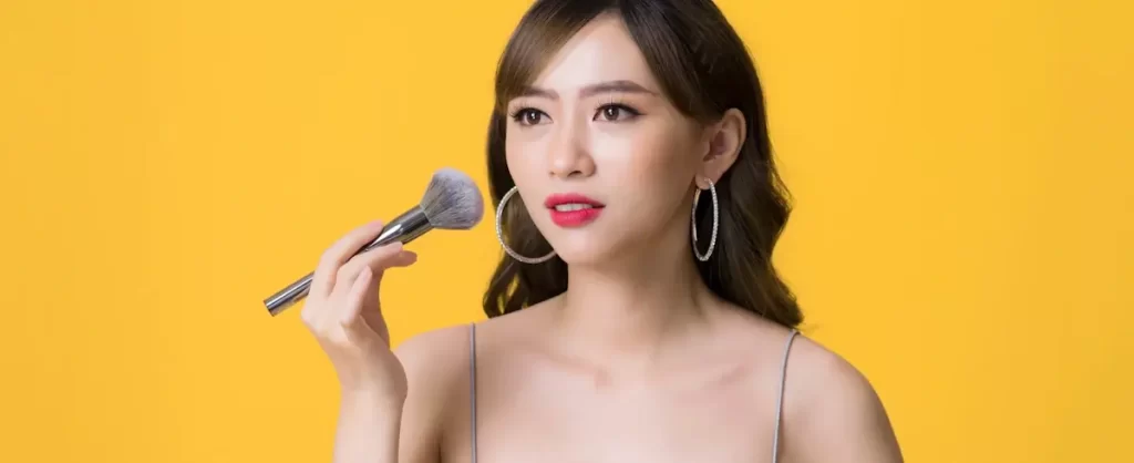 Photo young ladyboy making makeup using cosmetic brush