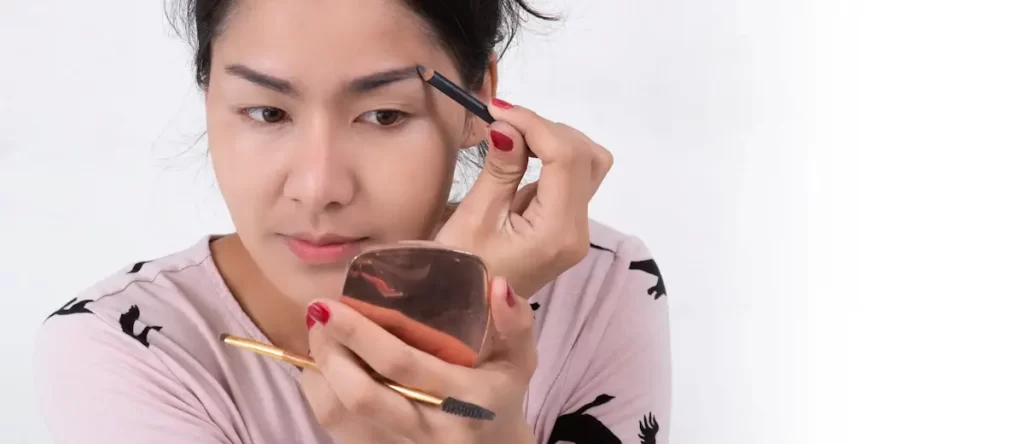 close up of beautiful face of young ladyboy getting make-up.